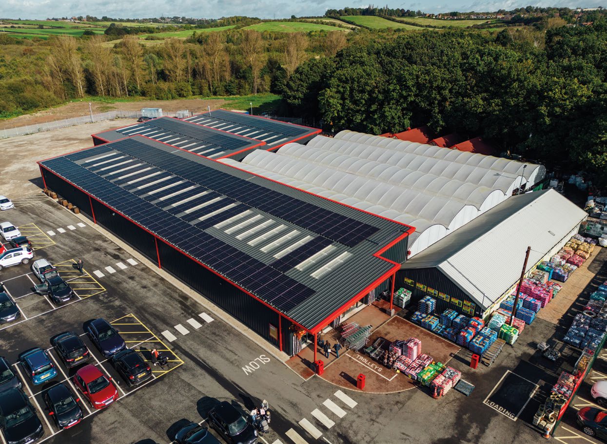 A drone-level view of Garden King's manufacturing facility buildings in Swadlincote. There have been various solar panels installed on the roof of the buildings.